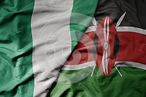 big waving national colorful flag of nigeria and national flag of kenya