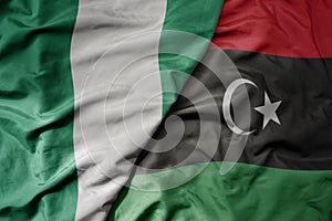 big waving national colorful flag of nigeria and national flag of libya