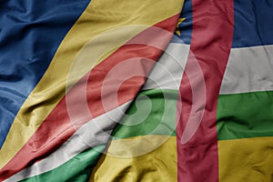 big waving national colorful flag of seychelles and national flag of central african republic