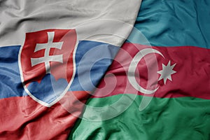 Big waving national colorful flag of slovakia and national flag of azerbaijan