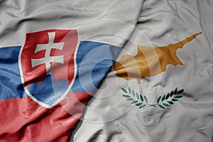 Big waving national colorful flag of slovakia and national flag of cyprus