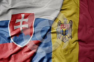 Big waving national colorful flag of slovakia and national flag of moldova