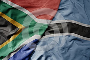 big waving national colorful flag of south africa and national flag of botswana
