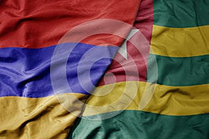 big waving national colorful flag of togo and national flag of armenia