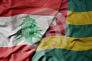 big waving national colorful flag of togo and national flag of lebanon