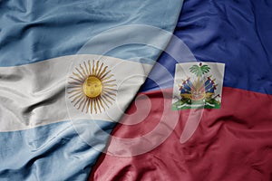big waving realistic national colorful flag of argentina and national flag of haiti
