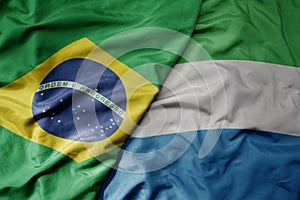 big waving realistic national colorful flag of brazil and national flag of sierra leone