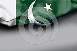 Big wavy Pakistan flag on white background textile fabric. White negative space is suitable for placing slogans.