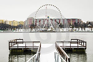 Big wheel covered with snow.Outdoor scenery in a public park in Bucharest.Beautiful scenery on a cold day after a snowy day.Landsc