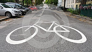 Big white bicycle sign on ground at residential street, concept for urban mobility and aternative transportation