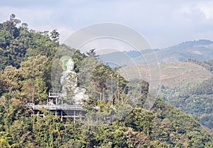 Big white buddha statue sitting on the mountain in Wat Tham Pha Jom temple at Maesai, Chiangrai, Thailand