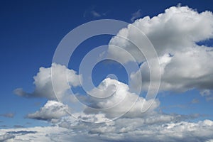 Big white fluffy clouds against blue sky.