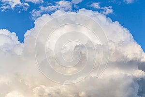 Big white fluffy cumulus cloud against blue sky background, cloud abstract texture