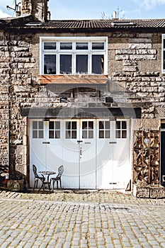 A big white garage door in a small house photo