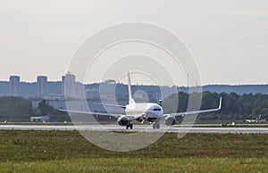 Big white passenger jet plane on runway at the airport