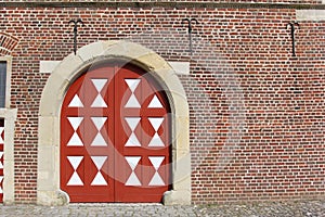 Big white-red door in the old stoned wall