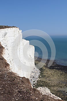 Big white rocks by the ocean and blue sky