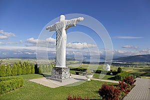 Big white Statue of Jesus over Landscape, Klin, Slovakia