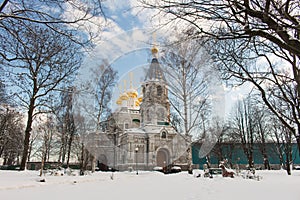 A big white stone church russian cathedral with golden domes