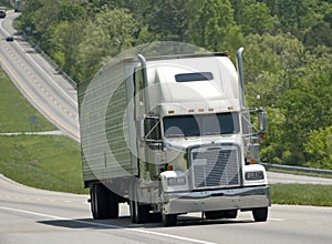 Big White Truck Climbing Hill On Interstate