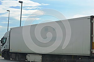 big white truck with a smiley face drawn on it