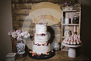 Big white wedding cake with fruit is on the table