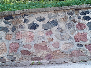 Big wild stone concrete wall with grass on top