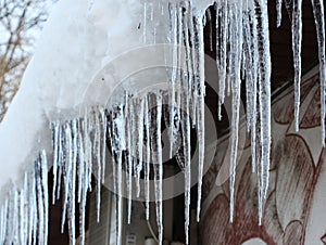 Big winter icicles at eaves on winter time - turturi periculosi la streasina photo