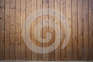 Big wooden barn gate. Monumental farm door, two timber leaf, closed brown gateway with planks and nails