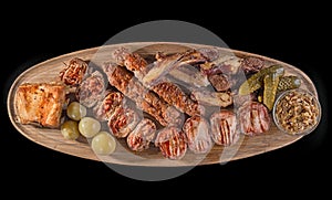 Big wooden board with assorted meats, preferably served as companion for beer or other alcohol drinks