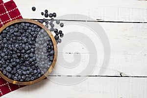 A big wooden bowl full of farm fresh, big blueberries