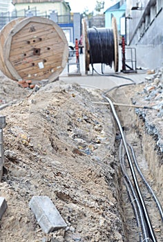 Big wooden coil of laying electric cable, optical fibers in the