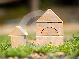 Big wooden home and small wooden home on grass. Home loan or building home or family concept. Home in nature