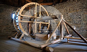 Big wooden millstone wheel in the castle