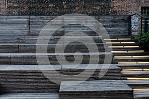 Big wooden steps for sitting in the High Line. Neon on the steps