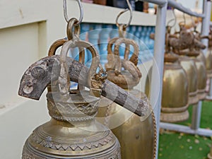 Big wooden stick was put on top of a temple bell ready for visitors to use for ringing the bells, as the sound of the bell is