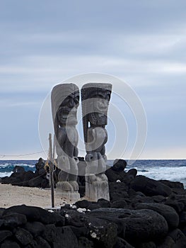 Big wooden Tiki sculpture in the in the Pu`uhonua o Honaunau National Park, Big Island, Hawaii