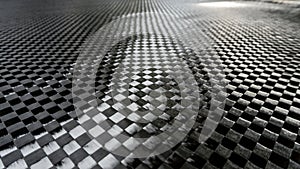 Big woven Black carbon fiber composite material background close up view