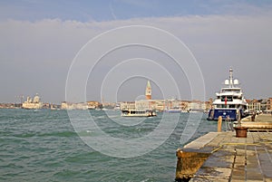 Big yacht near station Arsenale with Doges palace on the background. VENICE, ITALY