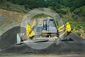 Big yellow bulldozer at work-site