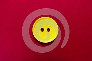 Big yellow button isolated on red background.