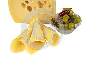 Big yellow cheese chunk and slices with olives