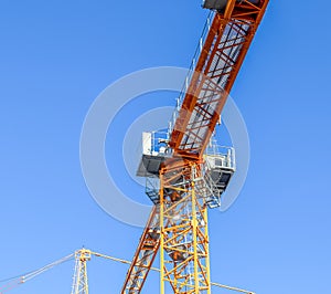 Big yellow cranes at a construction site in Kiel Germany on a sunny day with a clear blue sky