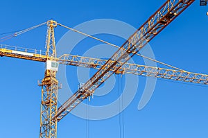 Big yellow cranes at a construction site in Kiel Germany on a sunny day with a clear blue sky