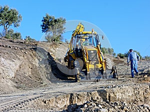 Big Yellow Digger Excavating New Dirt Road