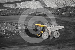 Big yellow mining truck body loaded anthracite. Open pit mine, extractive industry for coal