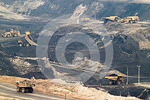 Big yellow mining truck and bulldozer at work industry site