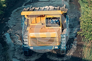 Big yellow mining truck in open pit mine industry