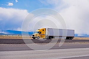 Big yellow rig semi truck trailer on highway in Utah photo