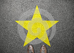 Big yellow star on floor with businessman shoes